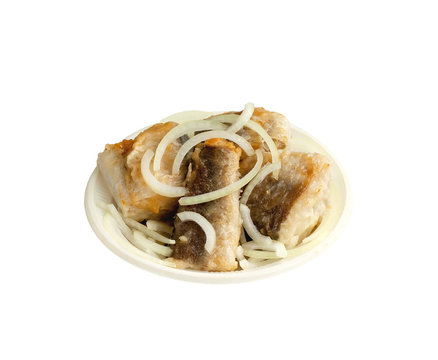 Appetizing pieces of fried fish with onions