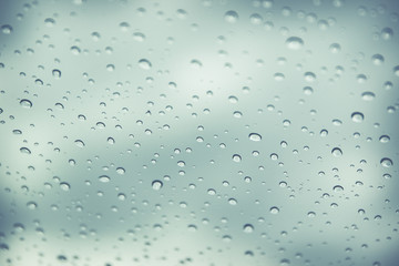Rain drop on car glass in background.