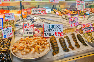 Variety of fresh seafood displayed on market stall.