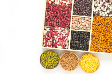 Different varieties of beans in a wooden box. Lentils different