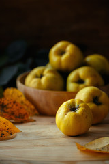 An autumn still life with quinces on wooden table