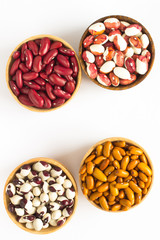 Four kinds of beans on white background. Top view