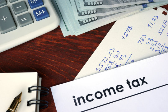 Income tax written on a paper. Financial concept.