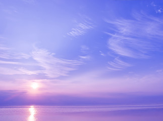 Naklejka na ściany i meble Beautiful sunset over the sea of blue and violet colors