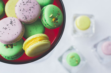 yellow, green and purple macaron cakes or macaroon on white background, sweet and colorful dessert, above, almond cookies, pastel color, vintage card, lavender, pistachios and almond on the background