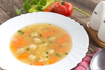 Soup with meatballs and vegetables in plate