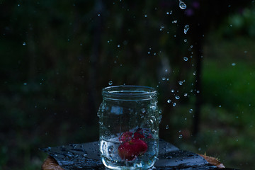 Apple falls into a jar of water