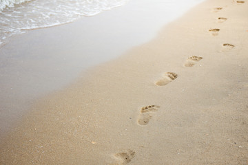 Foot print on sand at beach