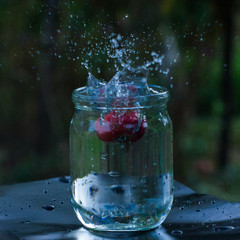 Apple falls into a jar of water