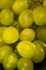 Bunch of grapes on a black slate stone