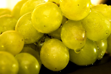 Bunch of grapes on a black slate stone