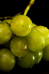 Bunch of grapes on a black slate stone