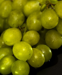 Bunch of grapes on a black slate stone