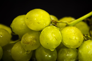 Bunch of grapes on a black slate stone