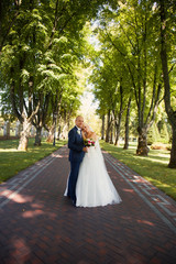 Newlyweds tenderly embraced in the park