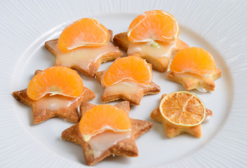 Fototapeta na wymiar Shortbread glazed cookies with tangerines