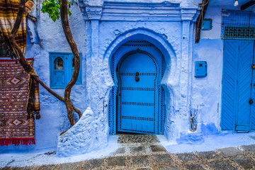 Traditional blue door on an old street inside Medina of Chefchaouen, Morocco