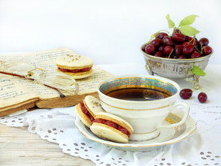 cup of espresso coffee and French macaroons dessert stuffed with cornel on light wooden background