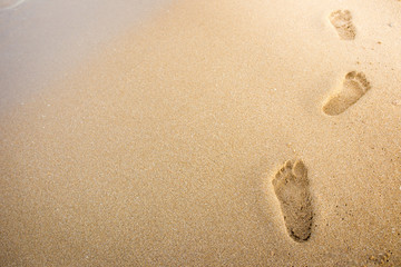 Foot print on sand at beach