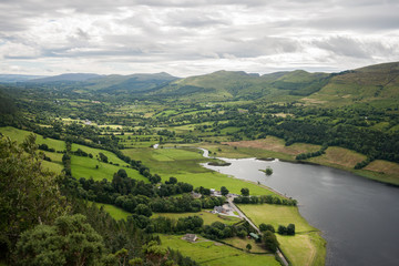 Green Irish countryside with hills and lake
