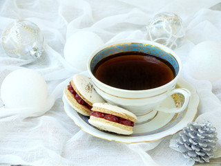 cup of espresso coffee, French macaroons dessert on light background. Christmas and New Year cookies