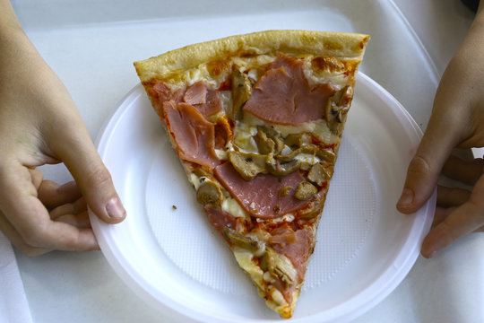 Pizza piece in human hands