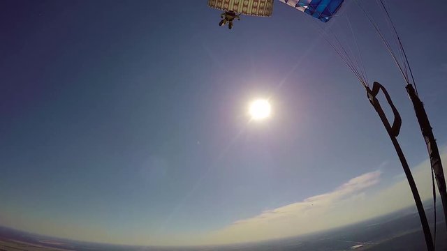 Aerial pov of skydiver flying on parachute