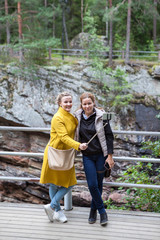 Obraz premium Two happy girlfriends making a photo on cellphone using the selfie stick
