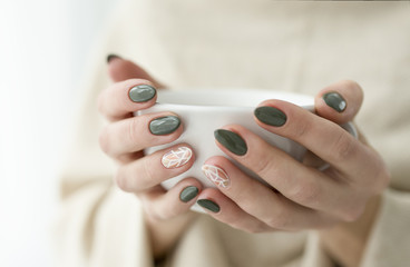 well-groomed hands with a cup of tea