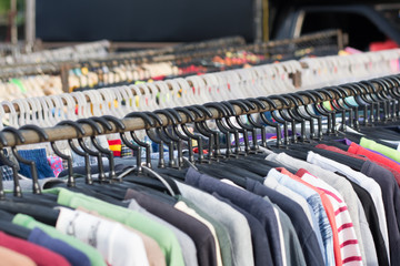 Fototapeta premium Selective focus some used leather clothes hanging on a rack in m