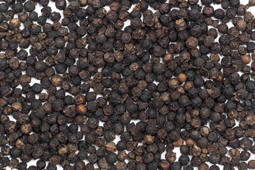 Black pepper grains as background