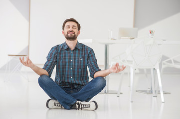 Young business man meditating