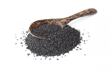 black sesame on wooden spoon isolated on white