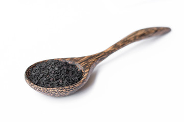 black sesame on wooden spoon isolated on white