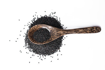 black sesame on wooden spoon isolated on white
