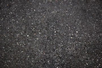 Dark black stone floor close up background.