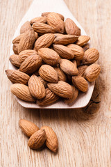 Almonds on wooden spoon
