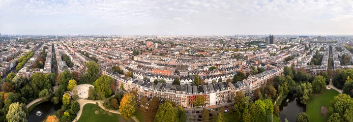 Rolgordijnen Aerial view of Amsterdam city roofs beside Sarphati park © alexkazachok
