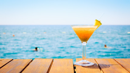 Concept of tropical vacation. Exotic cocktail on the pier. Luxur