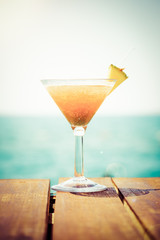 Concept of tropical vacation. Exotic cocktail on the pier. Luxur