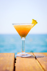 Concept of tropical vacation. Exotic cocktail on the pier. Luxur