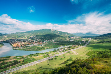 Fototapeta na wymiar Mtskheta Georgia. Aerial View Of Green Valley, Kura River Surrounded By Picturesque Mountains