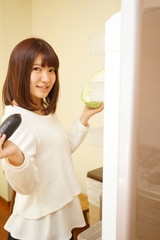 Young asian woman in front of the fridge