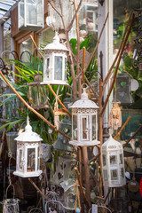 White iron lantern hanging on hawthorn branch © rostovdriver