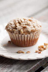 Walnut crumb sweet potato muffins on a weathered barn wood table