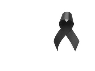 Black ribbon symbol for mourning on white background
