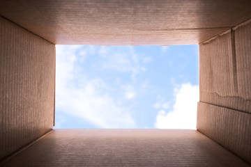 Concept image "Thinking Outside the Box" - Inside a cardboard with clear sky