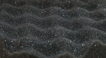Texture of black sponge wave with glitter from speaker