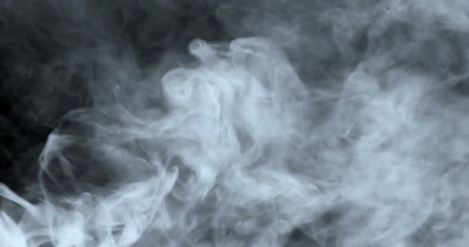 4K digital perfectly seamless loop of smoke slowly floating through space against black background