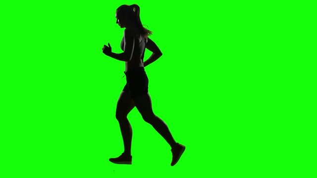 Running sport girl. Side view. Green screen. Silhouette